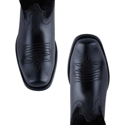 Botas vaqueras negras de tacón medio para looks casuales y de fiesta
